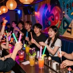 Dynamic nightlife scene at 상봉동 한국관나이트 with friends enjoying cocktails and dancing.